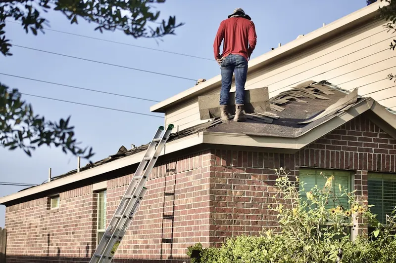 Professional roofer working on a residential roof in Nantucket Village